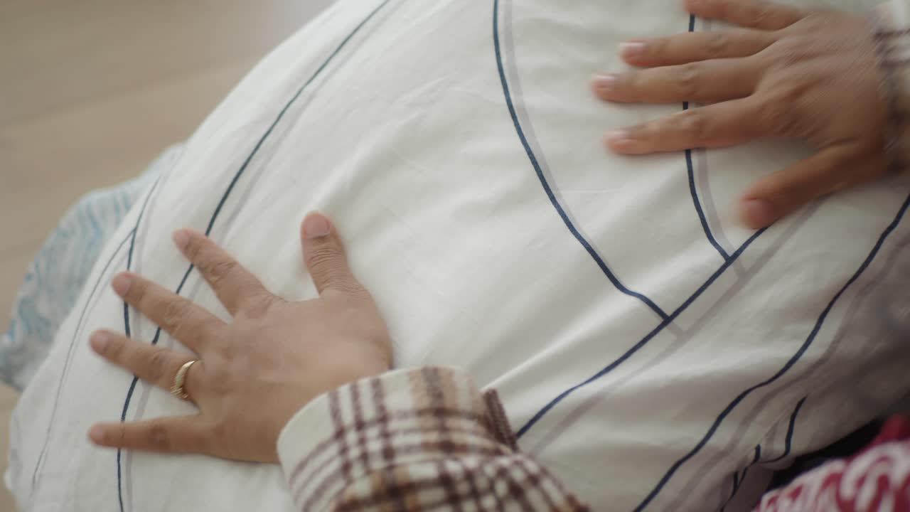 Close up of hand on bedding