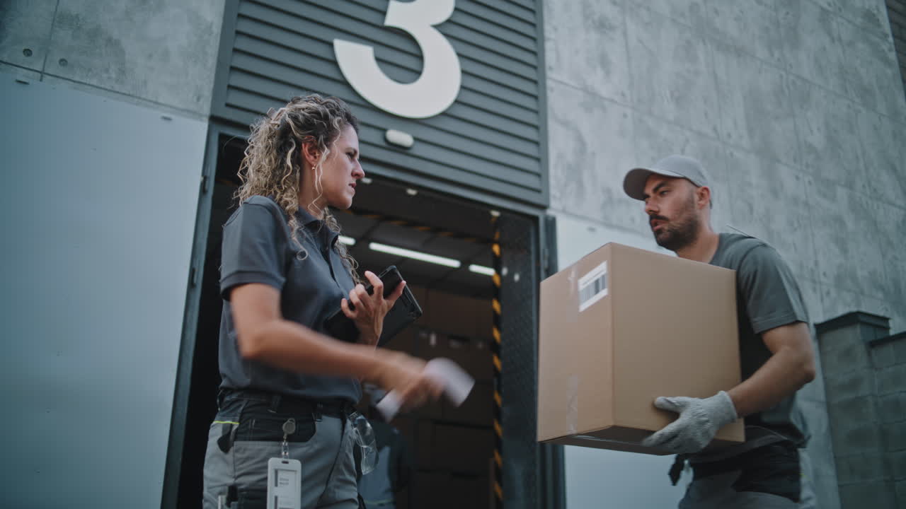 Workers managing packages at a modern logistics or distribution center