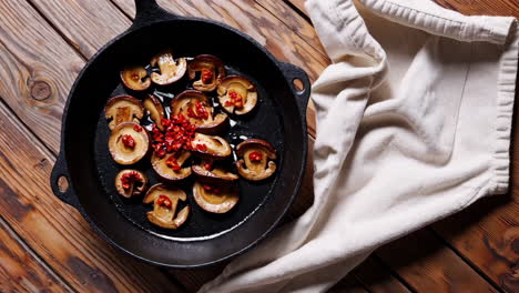 sautéing mushrooms with peppers in a cast iron pan