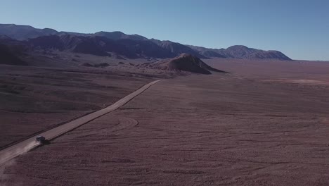 car driving in wild deserted landscape of atacama desert, chile, scenic road journey, bolivia