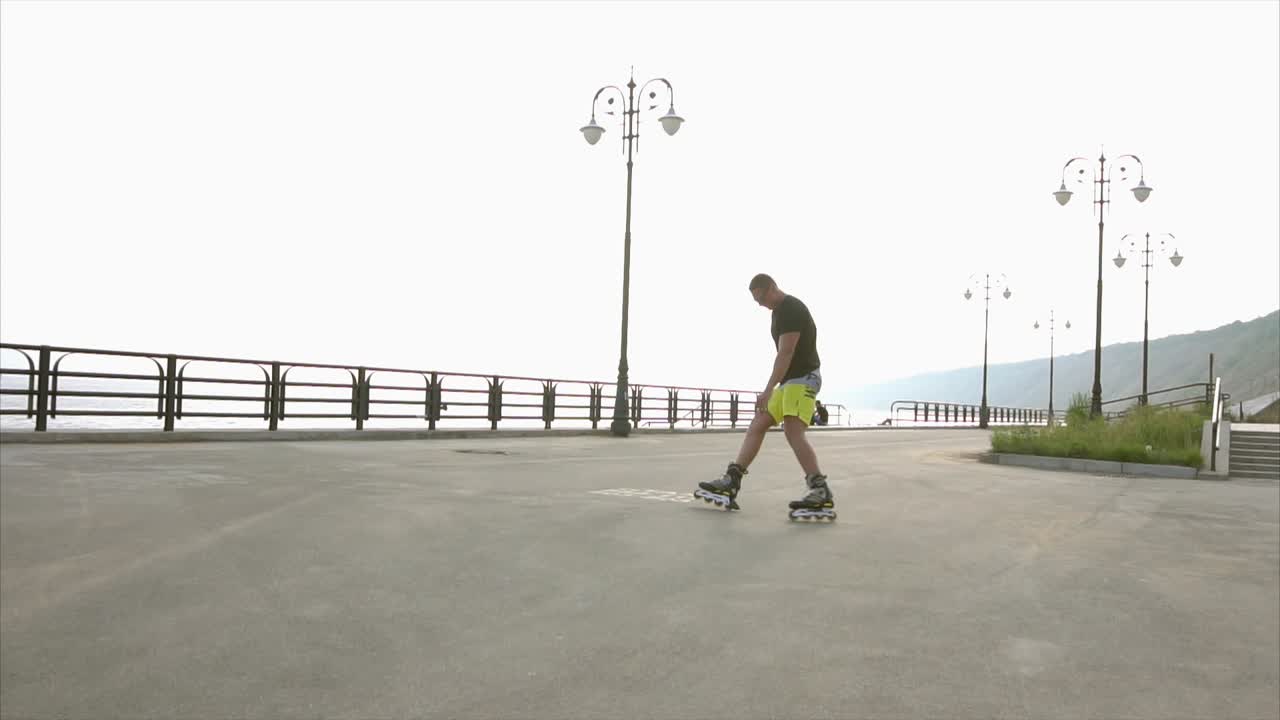 Man Rollerblading on a Waterfront Promenade