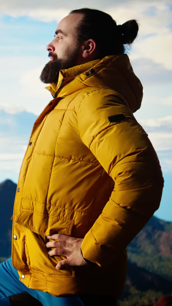 Bearded Man in Yellow Jacket Admiring Mountain View