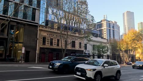 cars driving through a city street intersection