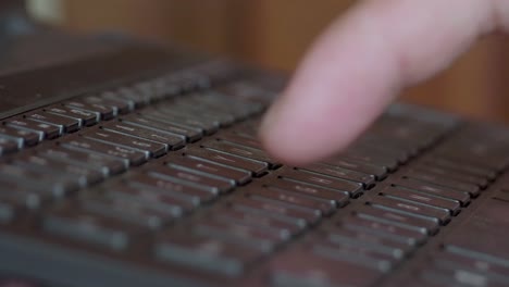 pressing computer laptop keyboard button with one finger, remote worker