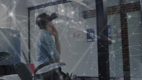 animation of network of connections over businessman using vr headset in office