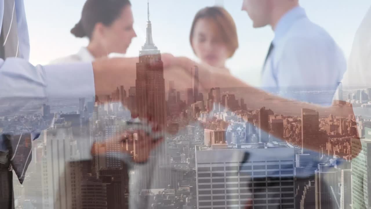 Composite video of mid section of businessman and businesswoman shaking hands against cityscape