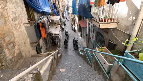 a bustling narrow street with scooters and buildings