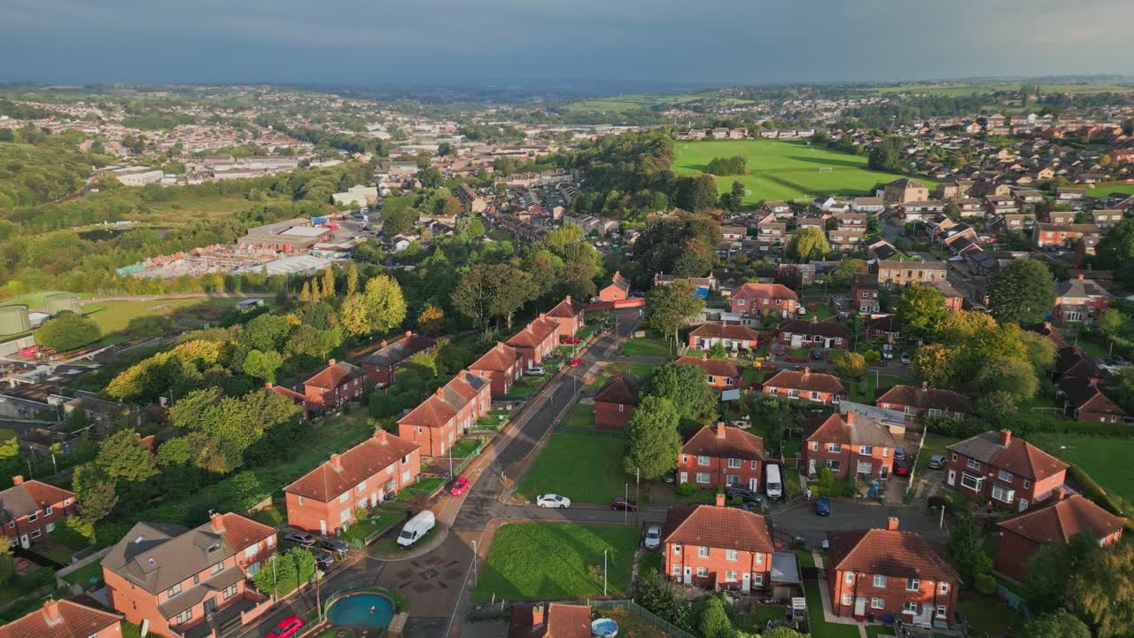 City life in the UK: Aerial view of Yorkshire's red brick council estate on a sunny morning, capturing the dynamic atmosphere of the community