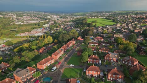 City-life-in-the-UK:-Aerial-view-of-Yorkshire's-red-brick-council-estate-on-a-sunny-morning,-capturing-the-dynamic-atmosphere-of-the-community