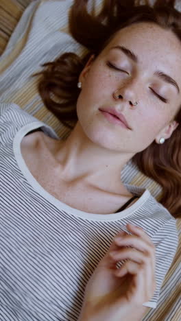 close-up of a young woman resting with eyes closed