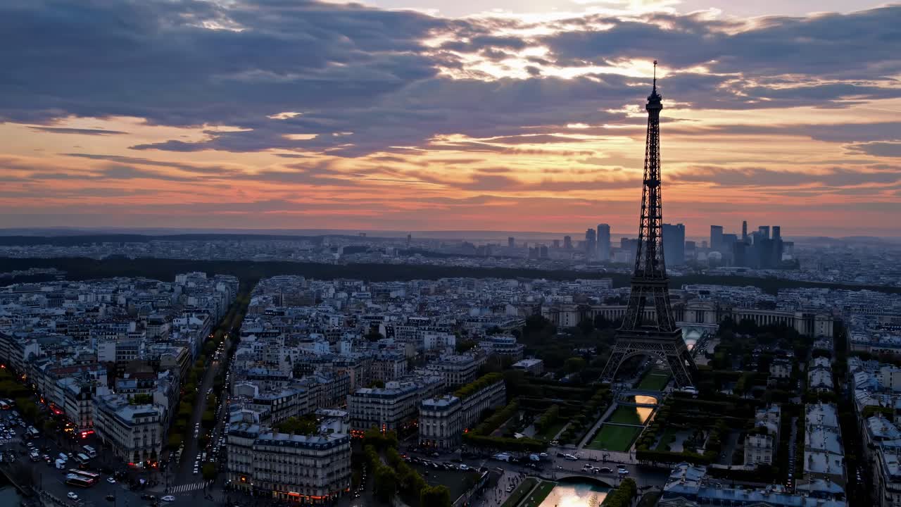 Aerial video captures Paris at sunset, highlighting the Eiffel Tower and cityscape from a high