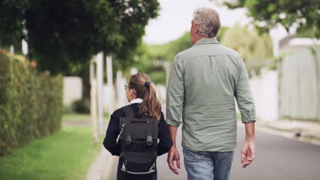 a-senior-man-walking-his-granddaughter-home