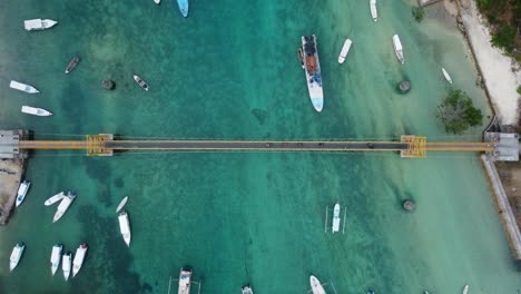 Aerial-4K-Drone-Footage:-Scooters-Crossing-the-Iconic-and-Picturesque-Yellow-Bridge-Connecting-Nusa-Lembongan-and-Nusa-Ceningan-Islands-in-Bali