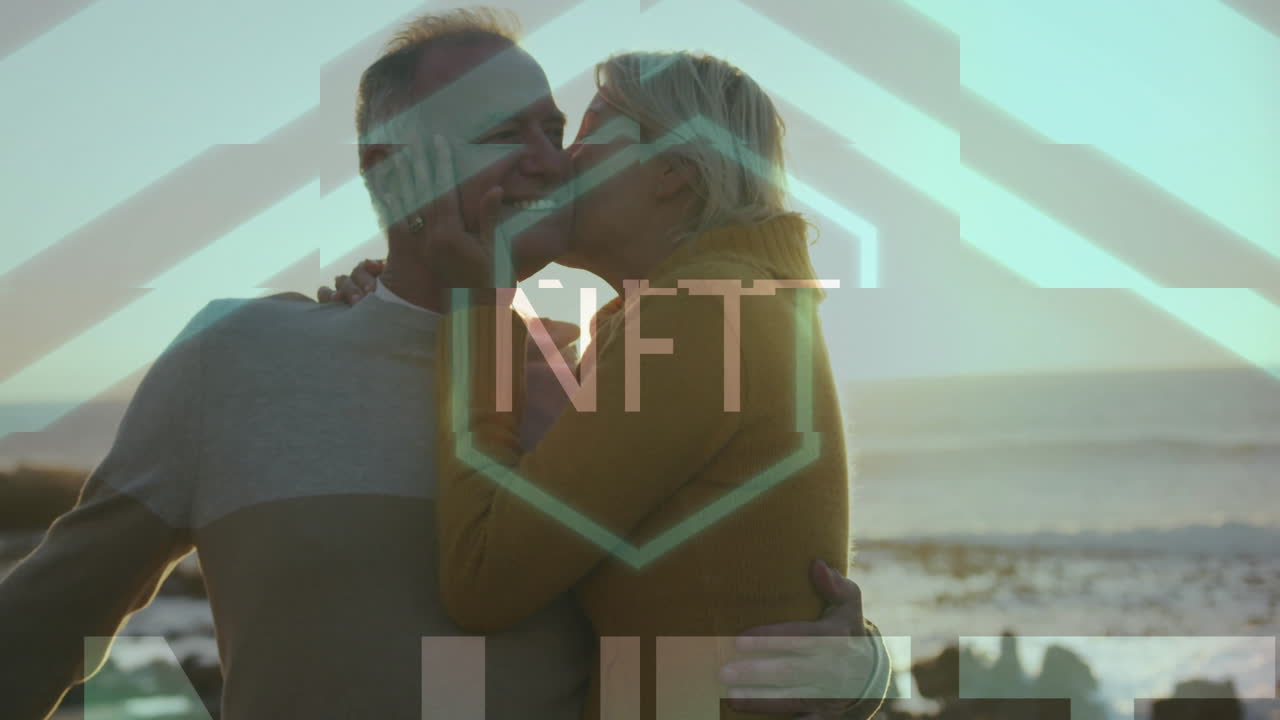 Elderly couple embracing by ocean with NFT text animation overlay