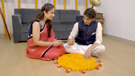 indian couple enjoying the process of decoration