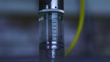 fluid inside transparent tube moves up and down as device activates in lab