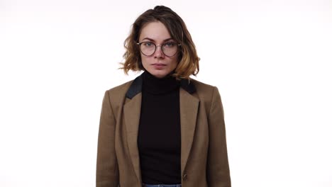 portrait of a young caucasian stressed girl shouting isolated over white background. stressed and depressed woman in brown jacket desperately gesturing and loudly, shout over limits