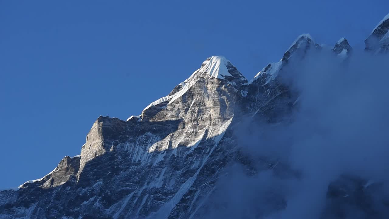 cerca de la cumbre rocosa y helada de langtang lirung contra un cielo azul