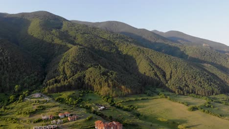 aerial view of pirin mountains and huge hills near small houses