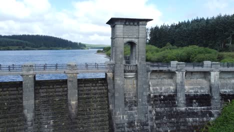 alwen reservoir welsh woodland lake water supply aerial view concrete dam countryside park rising tilt down shot