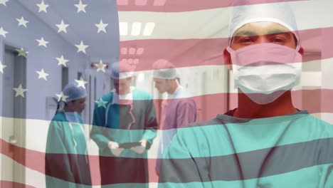 animation of flag of united states of america waving over surgeons in operating theatre