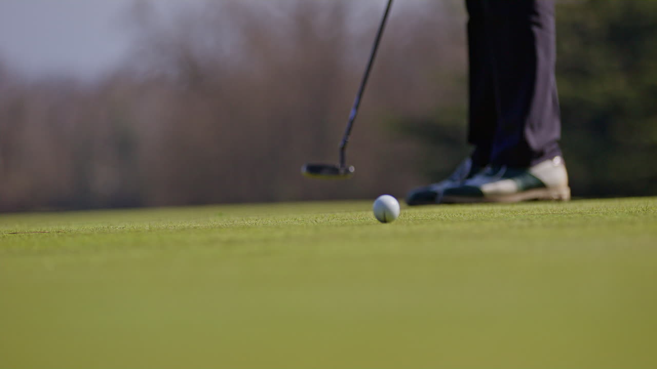 Young golfer playing on a sunny spring day in Switzerland, showcasing precise chipping, putting, bunker, and approach shots. Perfect for sports, lifestyle, and outdoor themes.