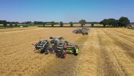 aerial view of modern agricultural machinery working efficiently in a harvested wheat field, showcasing advanced harvesting techniques and technology integration