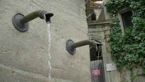 a small fountain somewhere in a town in france