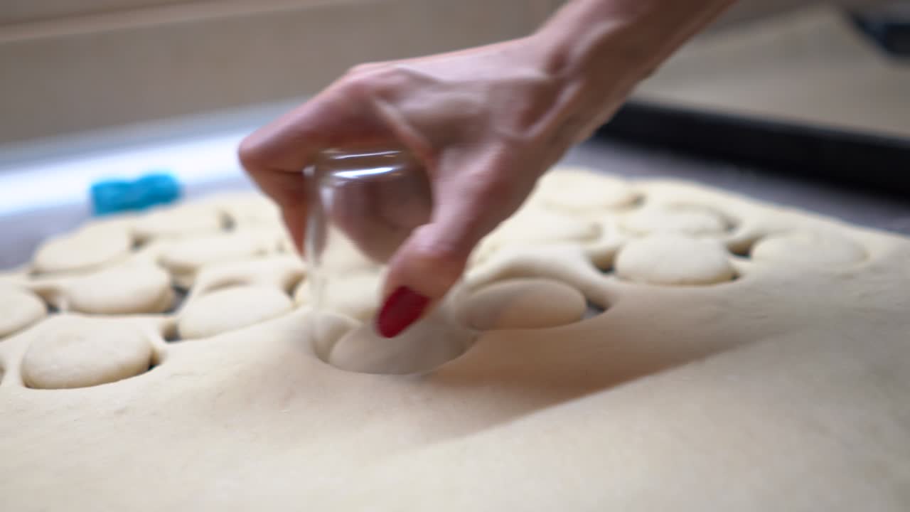 Cutting cookies with glass from a raw dough