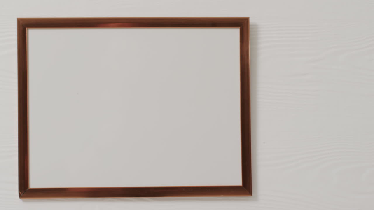 Wooden frame with copy space with white background and white wall
