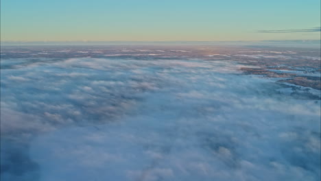 slow motion footage of flying above the clouds looking down on clouds and the earth below