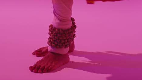 Close-Up-On-Feet-And-Bells-Of-Female-Kathak-Dancer-Performing-Dance-Wearing-Traditional-Indian-Dress-Against-Purple-Background-8