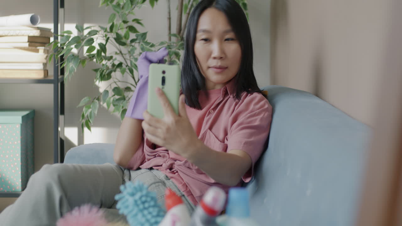 Woman Cleaning and Taking a Selfie