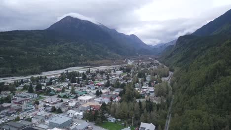 Skagway-Alaska,-Dark-Ominous-Mountainside,-Aerial-View-looking-over-the-City