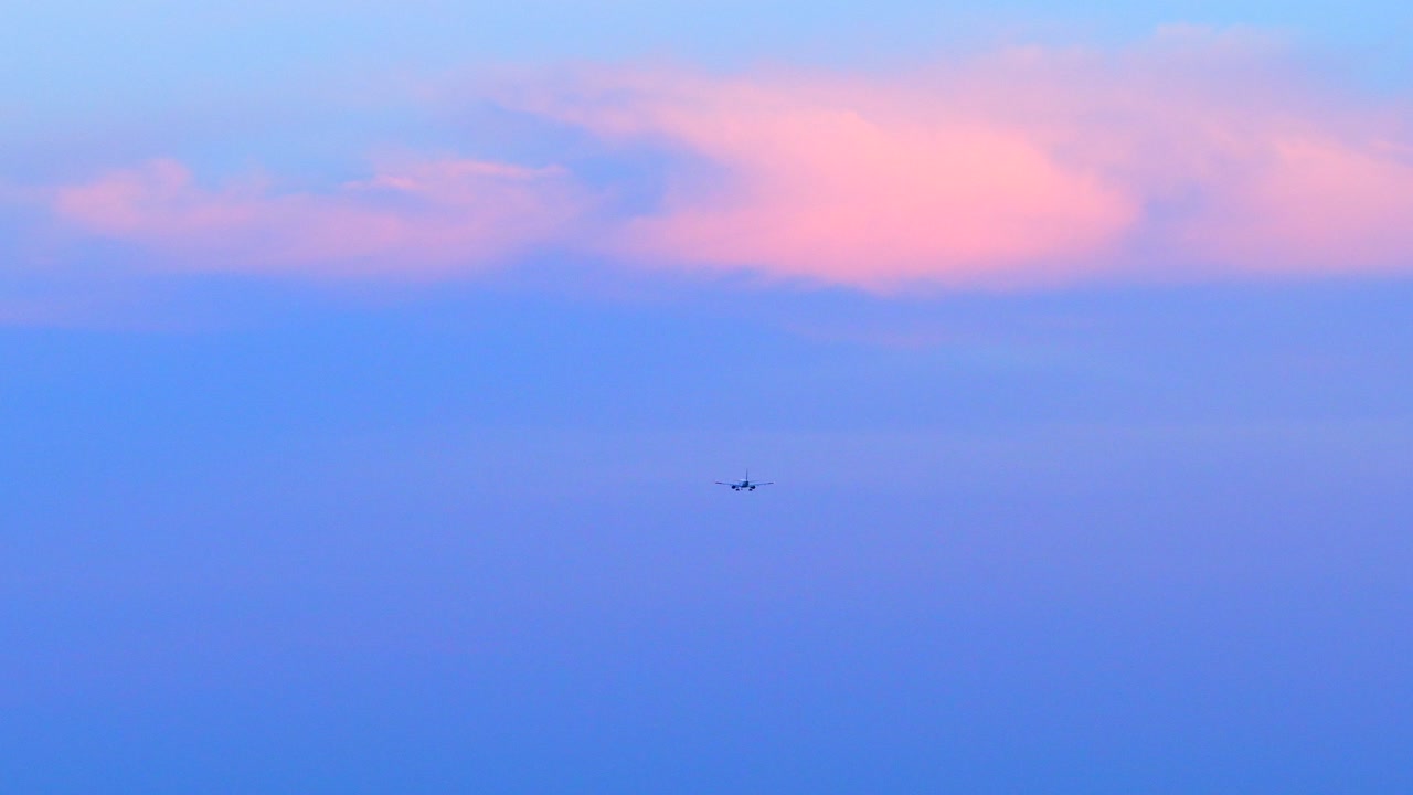 Airplane approaching Fryderyk Chopin Airport during the sunset