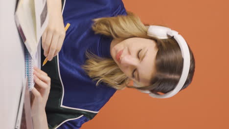 Vertical-video-of-Concentrated-young-woman-working-on-laptop.