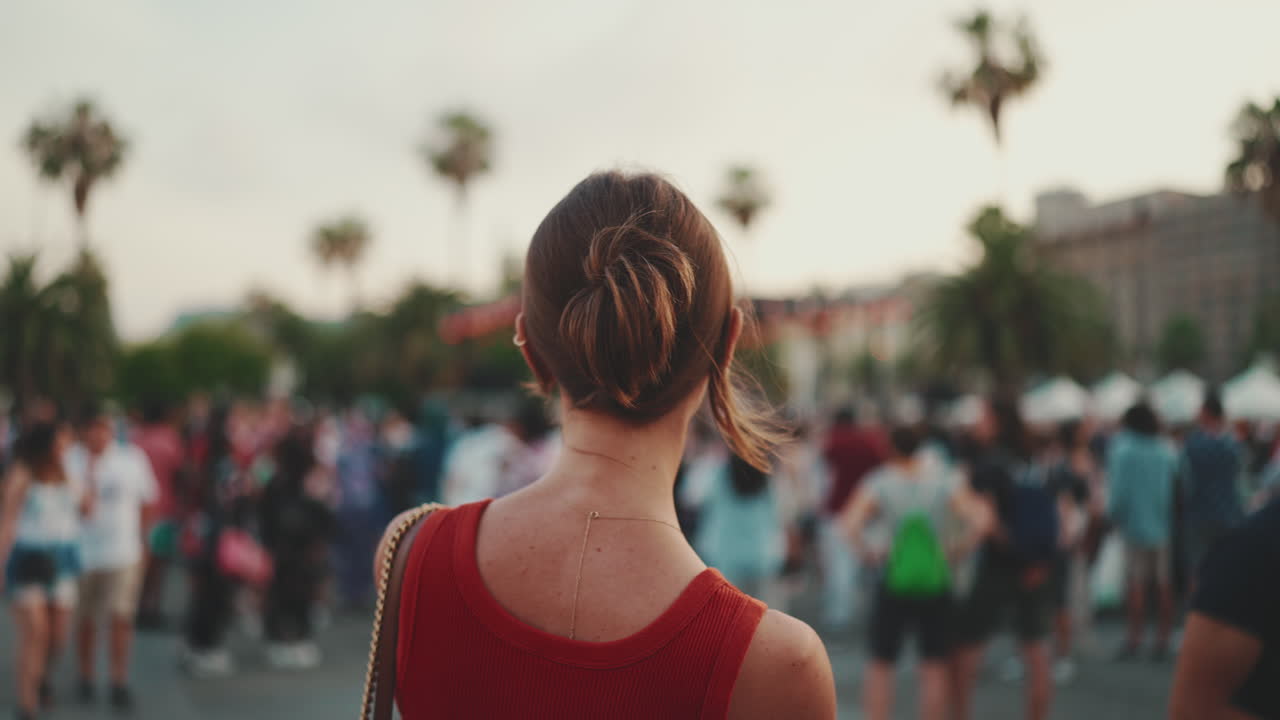 Woman in a crowd of people in a city