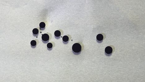 black ink dots on metal surface