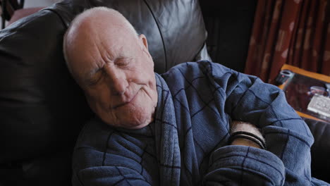 elderly man sleeping on couch