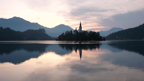 a beautiful reflection of lake bled at sunrise