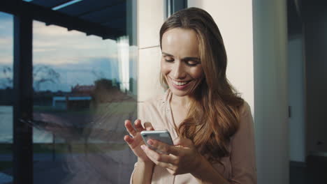 relaxed woman getting funny message on mobile. happy woman chatting on cellphone