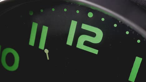 concept of time passing - the second hand of black and green wall clock turning - macro