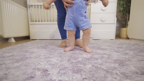 Baby's-first-step.-The-mother-is-trying-to-walk-her-baby.