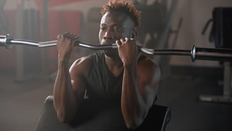 man working out with barbell in gym