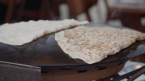 flatbreads cooking on a hot griddle