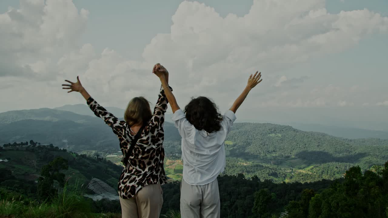 Two Women Celebrating a Scenic Mountain View