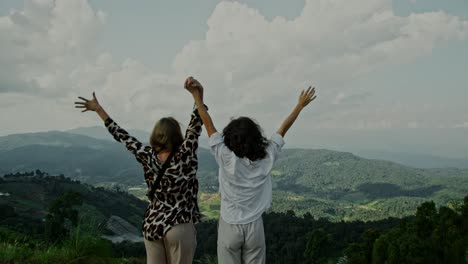 two women celebrating a scenic mountain view