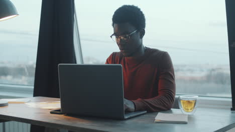 Black-Businessman-Using-Laptop-in-Rooftop-Office