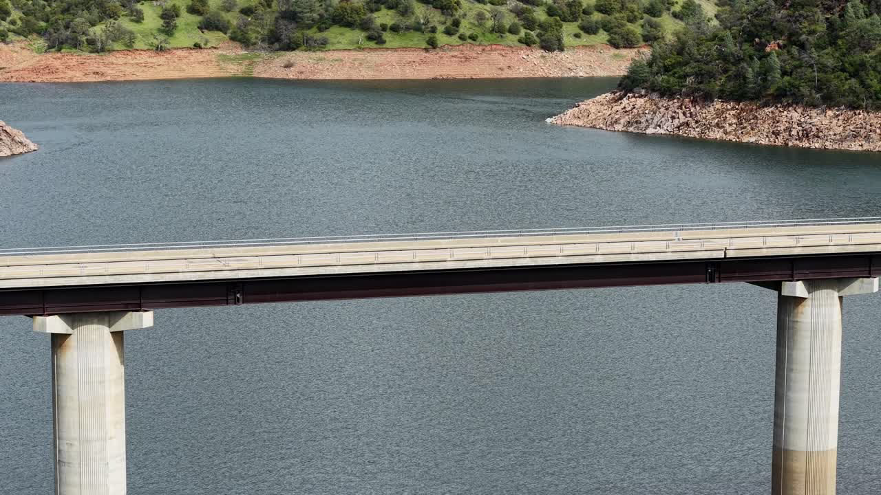 Flying over Don Pedro Reservoir, a drone showcases a close up of the bridge’s structure.