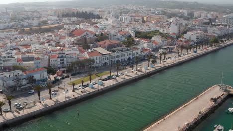 Aerial-drone-flying-above-sea-water-cannal-in-Lagos-harbor,-Portugal,-dolly-in,-day